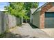 Side view of the exterior of the home with a gravel driveway and wooden fence at 9630 Crosscut Dr, Ladson, SC 29456
