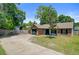 Front exterior view of single-story home with brick facade, green lawn, and long driveway at 9630 Crosscut Dr, Ladson, SC 29456