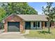 Charming single-story brick home with attached garage, landscaped yard, and inviting curb appeal at 9630 Crosscut Dr, Ladson, SC 29456