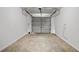 The garage is empty with a gray door at 9630 Crosscut Dr, Ladson, SC 29456