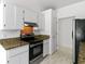 Bright kitchen with stainless steel oven, granite countertops, and white cabinets at 9630 Crosscut Dr, Ladson, SC 29456