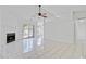 Open-concept living area featuring a fireplace, fan, tile floors, and natural light from a sliding door at 9630 Crosscut Dr, Ladson, SC 29456