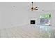 Spacious living room with fireplace, tile flooring, and sliding glass doors at 9630 Crosscut Dr, Ladson, SC 29456