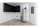 Utility Room features a water heater, cabinetry, and painted concrete floors at 9630 Crosscut Dr, Ladson, SC 29456