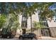 Modern building with dark window frames and doors framed with mature shade trees and street parking at 1 Cool Blow St # 337, Charleston, SC 29403