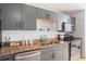 This is a kitchen featuring gray cabinets, granite countertops, and stainless steel appliances at 1 Cool Blow St # 337, Charleston, SC 29403