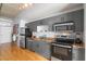 Modern kitchen featuring stainless steel appliances and sleek gray cabinetry with granite countertops at 1 Cool Blow St # 337, Charleston, SC 29403