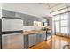 A modern kitchen featuring stainless steel appliances, gray cabinetry, and hardwood floors at 1 Cool Blow St # 337, Charleston, SC 29403