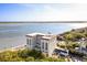 Aerial view of a high-rise building near the waterway surrounded by greenery and blue skies at 1 King St # 501, Charleston, SC 29401