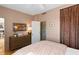 Warm bedroom with a full bath, wooden dresser, and serene decor at 1 King St # 501, Charleston, SC 29401