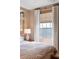 Bright bedroom showcasing a window with waterfront views, complemented by elegant curtains at 1 King St # 501, Charleston, SC 29401