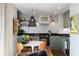 Modern kitchen features a marble dining table, custom cabinets, and sleek countertops, bathed in natural light at 1 King St # 501, Charleston, SC 29401