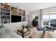 Inviting living room with custom built-ins, stylish decor, and serene water views from a large window at 1 King St # 501, Charleston, SC 29401