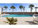 Serene pool area with lounge chairs and lush tropical landscaping at 1 King St # 501, Charleston, SC 29401