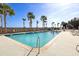 Inviting outdoor pool surrounded by palm trees and lounge chairs at 1 King St # 501, Charleston, SC 29401