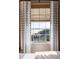 Window view with white curtains, bamboo shades, and scenic views of the river at 1 King St # 501, Charleston, SC 29401