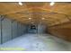Large metal garage interior featuring hydraulic car lift with a vehicle at 1044 Towhee Ln, McClellanville, SC 29458