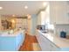 Well-lit kitchen with white cabinets, quartz countertops, and hardwood floors at 1044 Towhee Ln, McClellanville, SC 29458