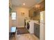 Well-organized laundry room features modern appliances, ample storage, and convenient access to the exterior at 1044 Towhee Ln, McClellanville, SC 29458