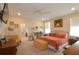 Bright main bedroom with a ceiling fan, a dresser, and an ensuite bathroom entrance at 1044 Towhee Ln, McClellanville, SC 29458