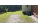 Lush backyard with partially fenced yard, mature tree, and outdoor HVAC unit at 107 Kelly St, Walterboro, SC 29488