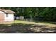 Fenced backyard featuring two storage sheds with mature trees in the background at 107 Kelly St, Walterboro, SC 29488