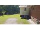 Lush backyard with partially fenced yard, mature tree, and outdoor HVAC unit at 107 Kelly St, Walterboro, SC 29488