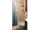 Clean bathroom featuring a walk-in shower with safety grab bars and curtain at 107 Kelly St, Walterboro, SC 29488