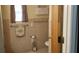 Neutral tiled bathroom with window and white wicker storage shelf at 107 Kelly St, Walterboro, SC 29488