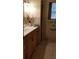 View of tiled bathroom with vanity, sink and window at 107 Kelly St, Walterboro, SC 29488