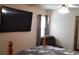 Bedroom with TV, floral bedding, window, and gray curtains at 107 Kelly St, Walterboro, SC 29488
