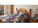 Bedroom with floral bedding, wood headboard, and night stand at 107 Kelly St, Walterboro, SC 29488