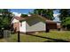 Charming exterior features a brick and siding facade, a red roof, and a fenced yard at 107 Kelly St, Walterboro, SC 29488