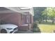 Charming red-brick home featuring a covered front porch and landscaped yard at 107 Kelly St, Walterboro, SC 29488