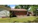 View of home featuring a metal roof, brick and siding accents, as well as an outdoor HVAC unit at 107 Kelly St, Walterboro, SC 29488