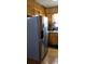 Kitchen featuring a stainless steel refrigerator and classic wooden cabinetry for ample storage at 107 Kelly St, Walterboro, SC 29488