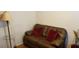 Cozy living room area with a leather love seat and decorative floor lamp at 107 Kelly St, Walterboro, SC 29488
