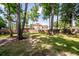 Wide backyard with mature trees and a wooden fence for added privacy at 107 Spalding Cir, Goose Creek, SC 29445