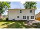 Rear exterior view of a home with white siding, a small patio, and a well-maintained grassy yard at 107 Spalding Cir, Goose Creek, SC 29445