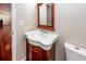 Half bath with a dark wood vanity, traditional mirror, and hardwood floors at 107 Spalding Cir, Goose Creek, SC 29445