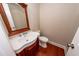 Traditional half bath with a dark wood vanity and decorative mirror at 107 Spalding Cir, Goose Creek, SC 29445