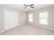 Cozy bedroom with neutral carpet, a ceiling fan, and a double window providing natural light at 107 Spalding Cir, Goose Creek, SC 29445