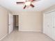 Bedroom with a ceiling fan, closet, carpet, and access to another room with an open door at 107 Spalding Cir, Goose Creek, SC 29445