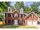 Beautiful brick two-story home with black shutters, dormer windows and a two-car garage at 107 Spalding Cir, Goose Creek, SC 29445
