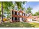 Attractive two-story brick home with black shutters and a two-car garage set on a well-manicured lawn at 107 Spalding Cir, Goose Creek, SC 29445