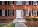 Close up of front door with sidelights, black sconces, and dark mulch landscape at 107 Spalding Cir, Goose Creek, SC 29445