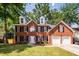 Two story brick home with black shutters, white trim, and two car garage at 107 Spalding Cir, Goose Creek, SC 29445
