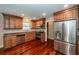 Well-lit kitchen with stainless steel appliances, hardwood floors, and granite counters at 107 Spalding Cir, Goose Creek, SC 29445