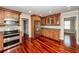 Traditional kitchen features granite counters, stainless appliances and rich hardwood floors at 107 Spalding Cir, Goose Creek, SC 29445