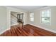 Living room with wood floors, white trim, and a staircase leading to the upper floor at 107 Spalding Cir, Goose Creek, SC 29445